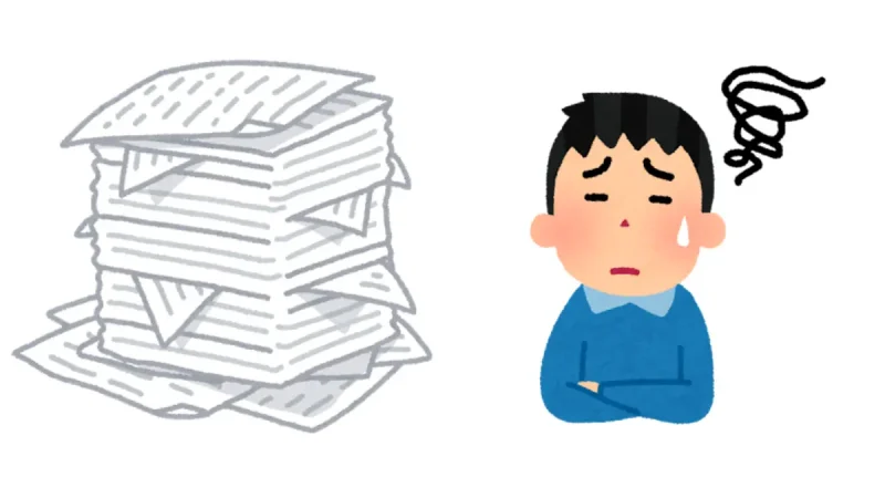 書類の山を見て困惑している人,A confused man looking at a pile of documents